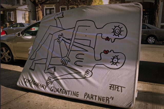 A photo of a mattress on the street with a drawing of "imaginary quarantine partners"